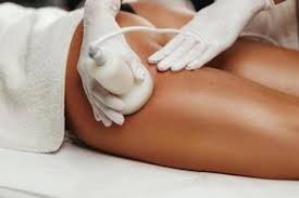 Handheld RF device applying radio frequency treatment to thigh for skin tightening and contouring at Superior Sculpting.